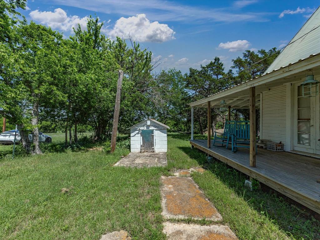 5444 Well Service Road Bowie, TX 76230 - Photo 31 of 38 a front view of a house with garden