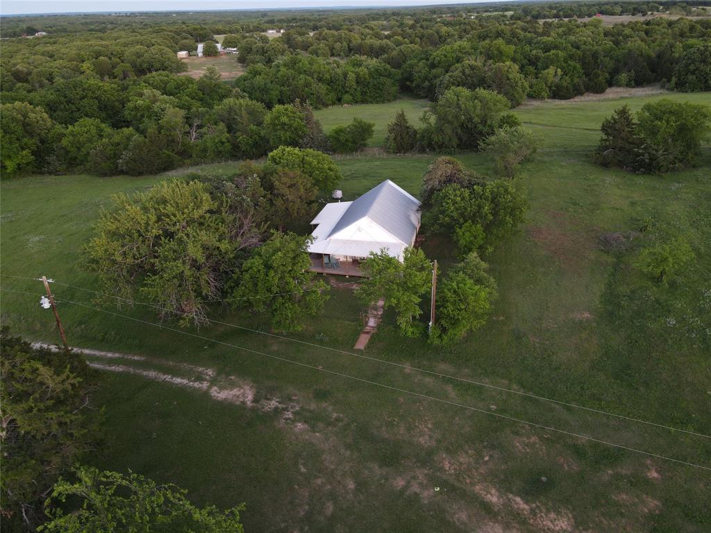 5444 Well Service Road Bowie, TX 76230 - Photo 6 of 38 a backyard of a house with a yard and outdoor seating
