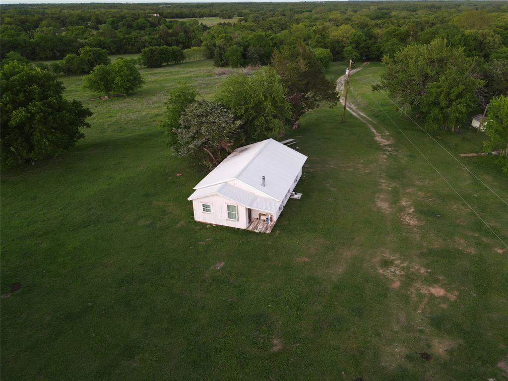 5444 Well Service Road Bowie, TX 76230 - Photo 7 of 38 an aerial view of a house with a yard