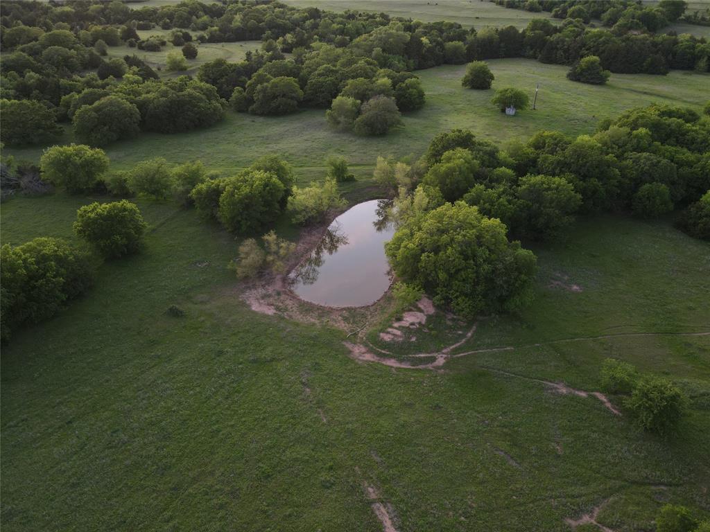 5444 Well Service Road Bowie, TX 76230 - Photo 8 of 38 an aerial view of a house with a yard