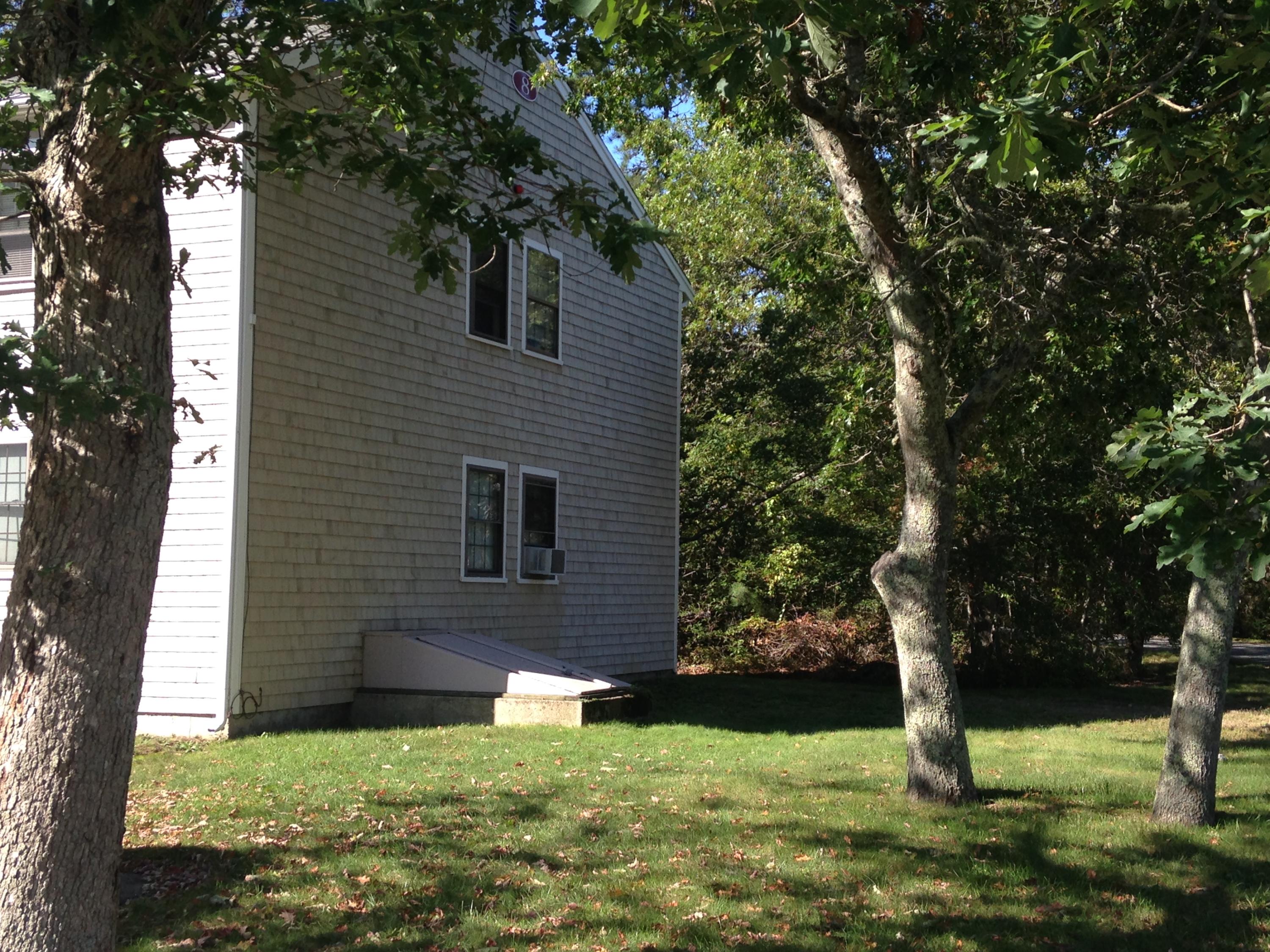 35 Ashumet Road, Unit 8D Mashpee, MA 02649 - Photo 16 of 16 a view of a backyard with plants and large trees