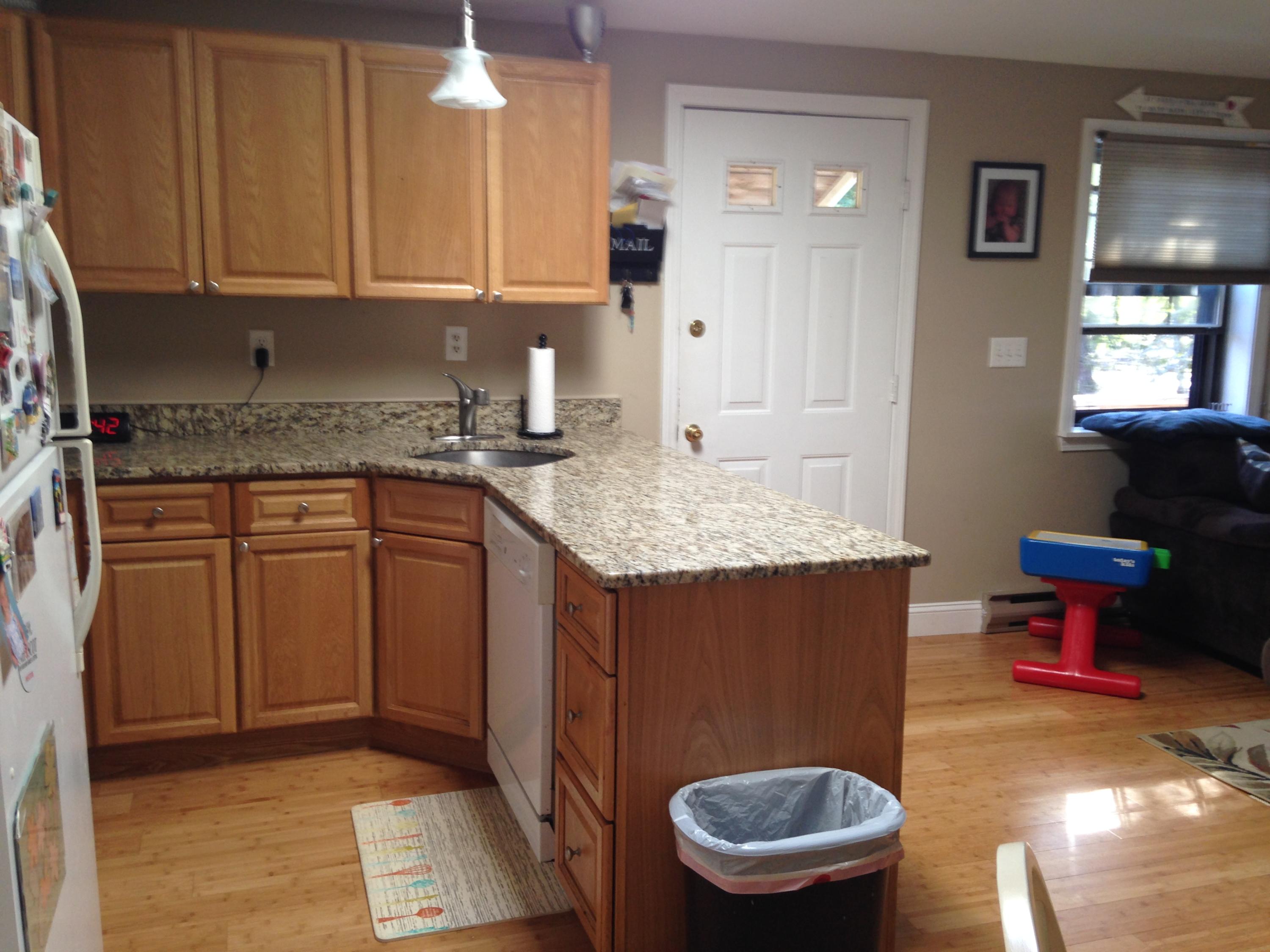35 Ashumet Road, Unit 8D Mashpee, MA 02649 - Photo 2 of 16 a kitchen with a sink cabinets and wooden floor