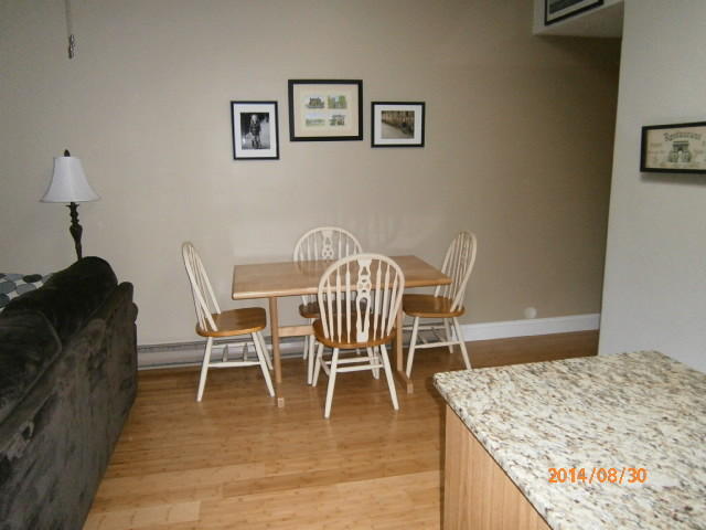 35 Ashumet Road, Unit 8D Mashpee, MA 02649 - Photo 5 of 16 a dining room with furniture and wooden floor
