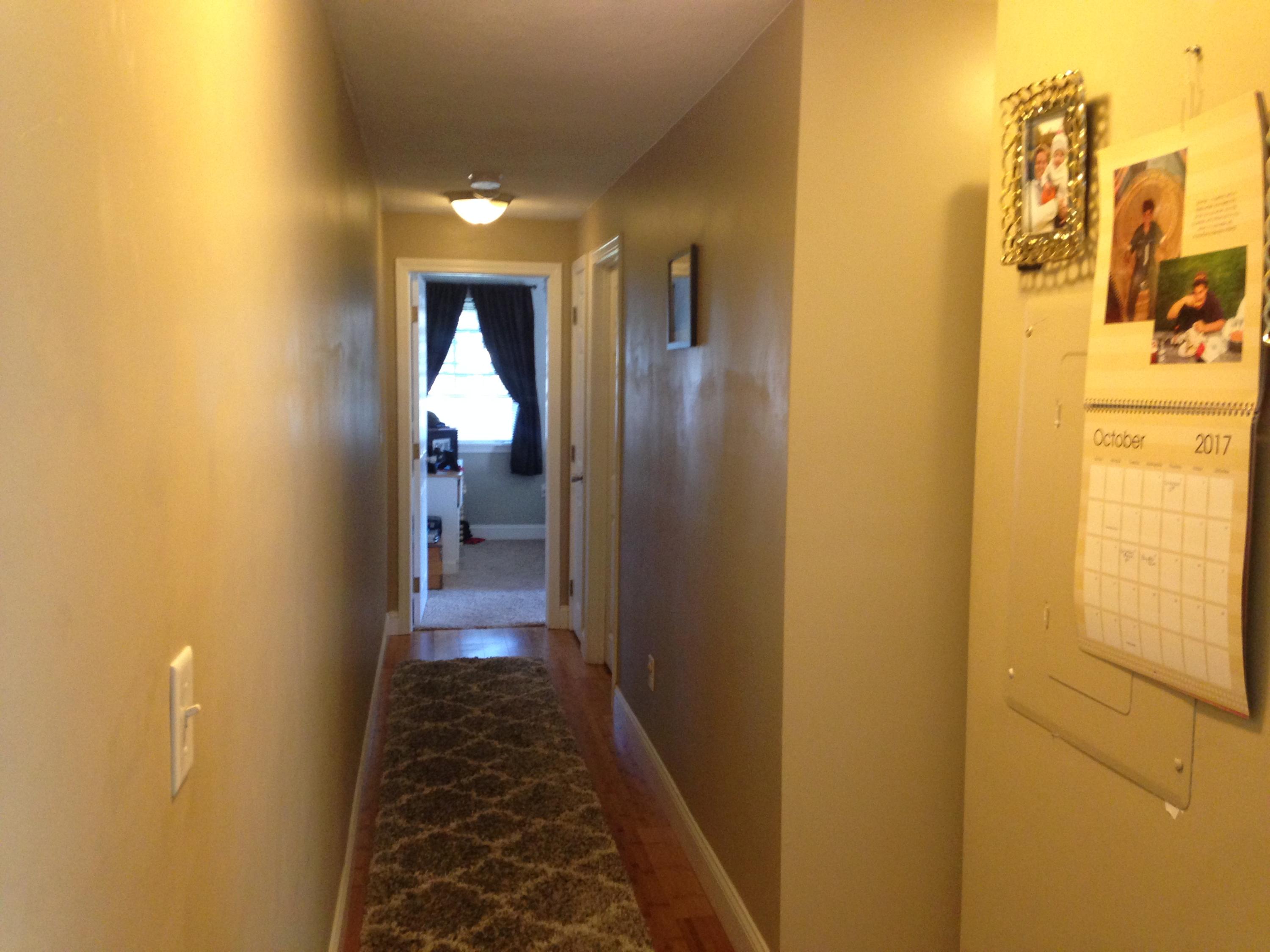 35 Ashumet Road, Unit 8D Mashpee, MA 02649 - Photo 6 of 16 a view of a hallway with a yellow walls