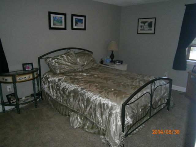 35 Ashumet Road, Unit 8D Mashpee, MA 02649 - Photo 7 of 16 a bed sitting in a bedroom next to a window