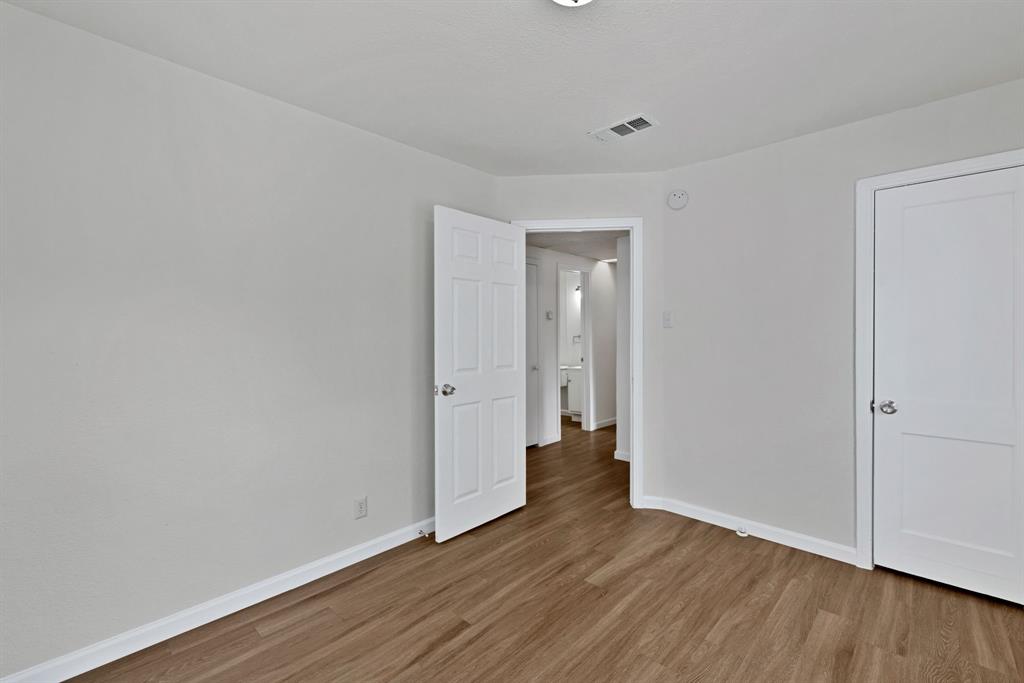 613 Cheyenne Road Dallas, TX 75217 - Photo 16 of 28 Room featuring wood-finish flooring and neutral wall tones