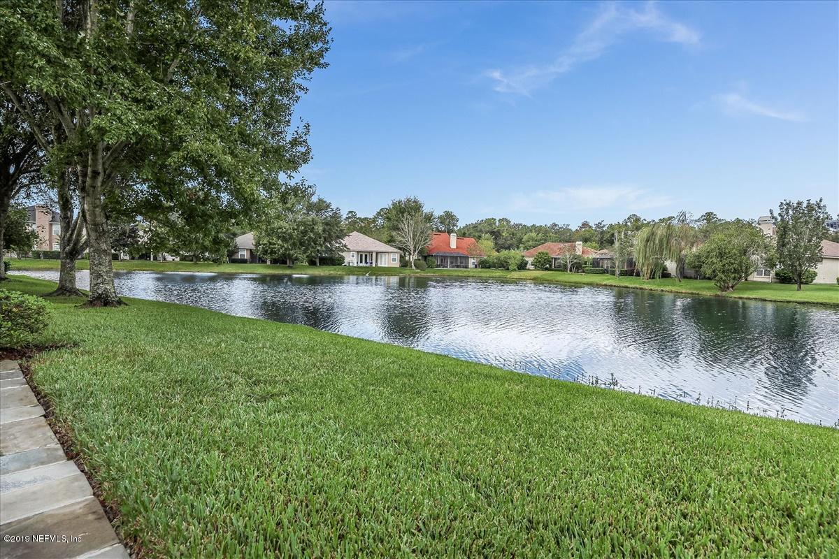 1256 Paradise Pond Road St. Augustine, FL 32092 - Photo 31 of 56 a view of a lake with houses in the back