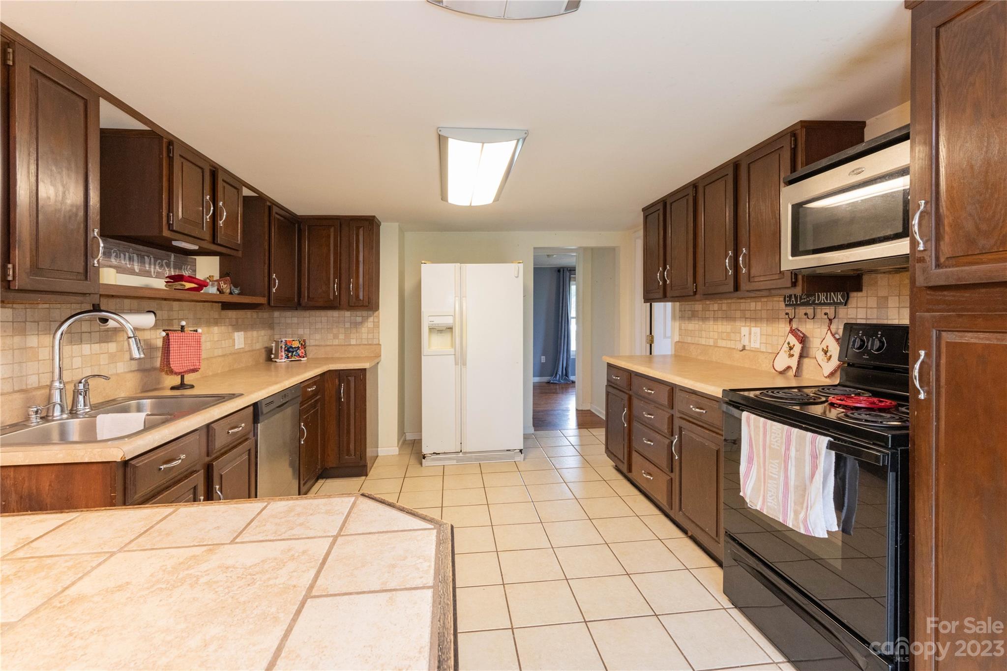 558 Jacktown Road Marion, NC 28752 - Photo 11 of 26 a large kitchen with stainless steel appliances and cabinets
