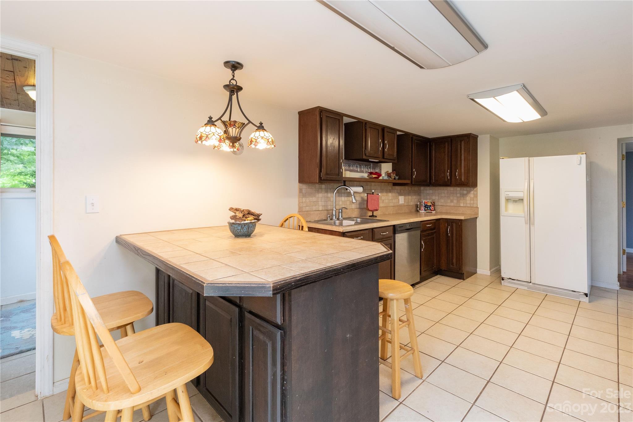 558 Jacktown Road Marion, NC 28752 - Photo 12 of 26 a kitchen with a sink a refrigerator and cabinets