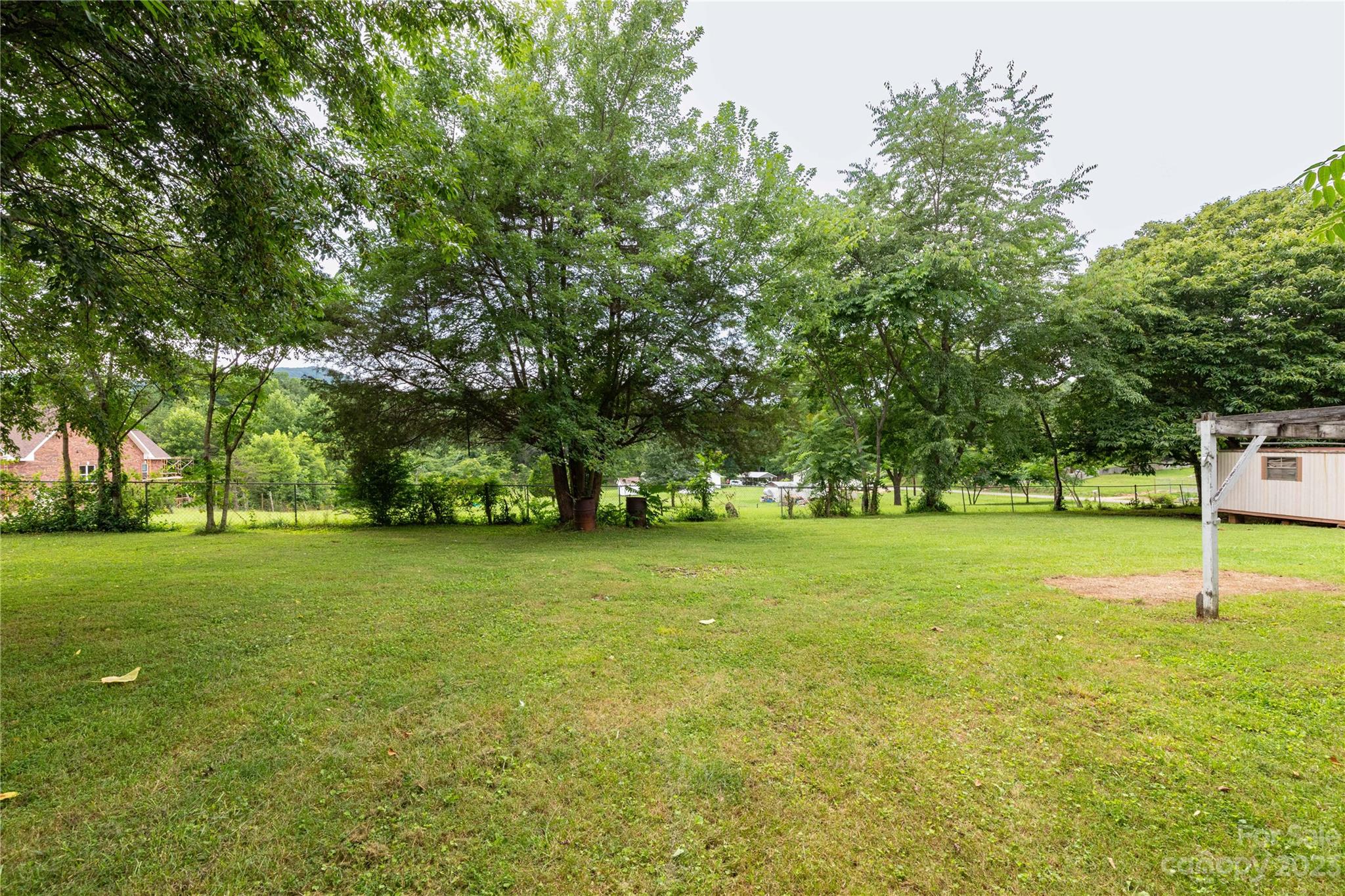 558 Jacktown Road Marion, NC 28752 - Photo 15 of 26 a garden with trees in front of it