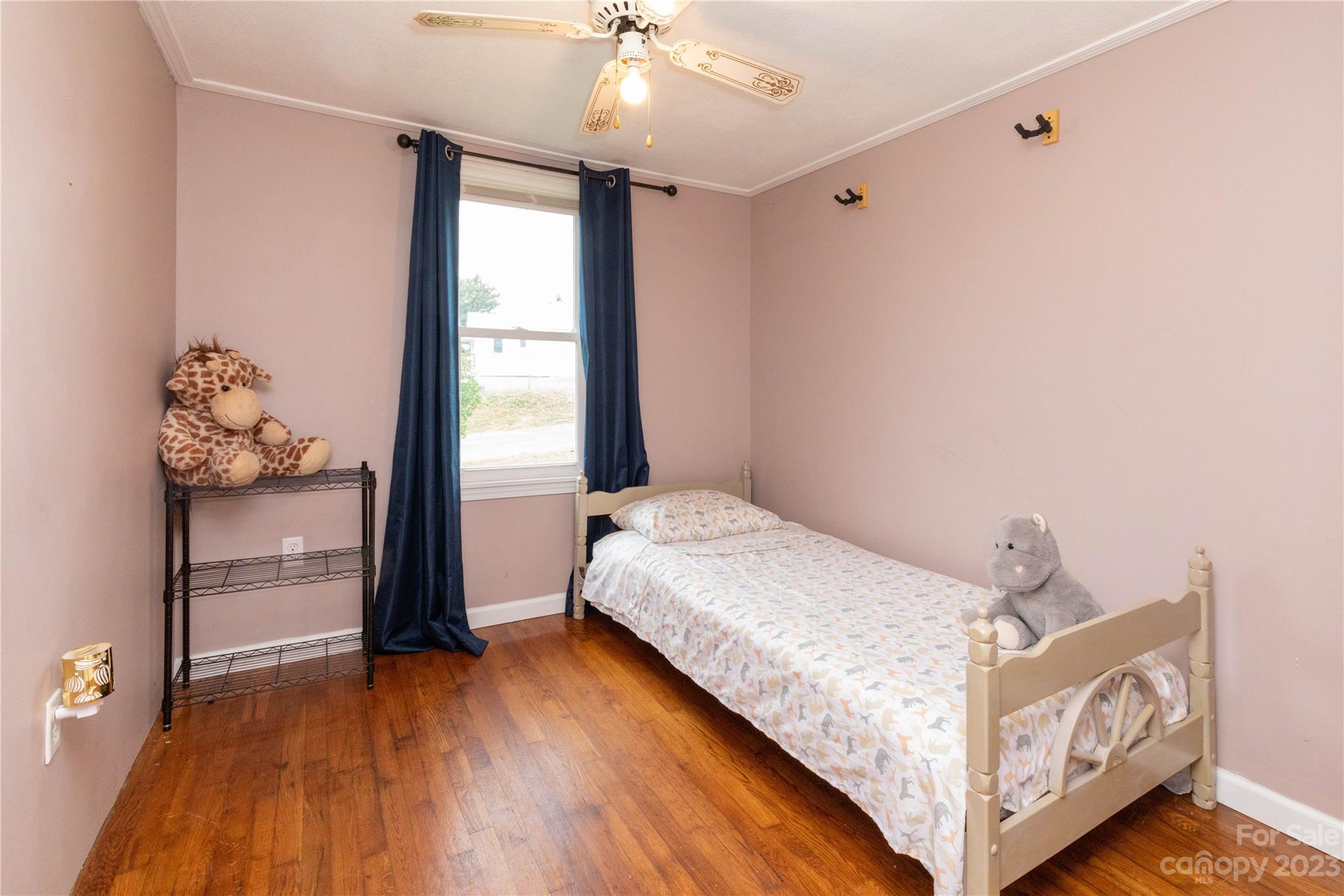 558 Jacktown Road Marion, NC 28752 - Photo 2 of 26 a bedroom with a bed and wooden floor