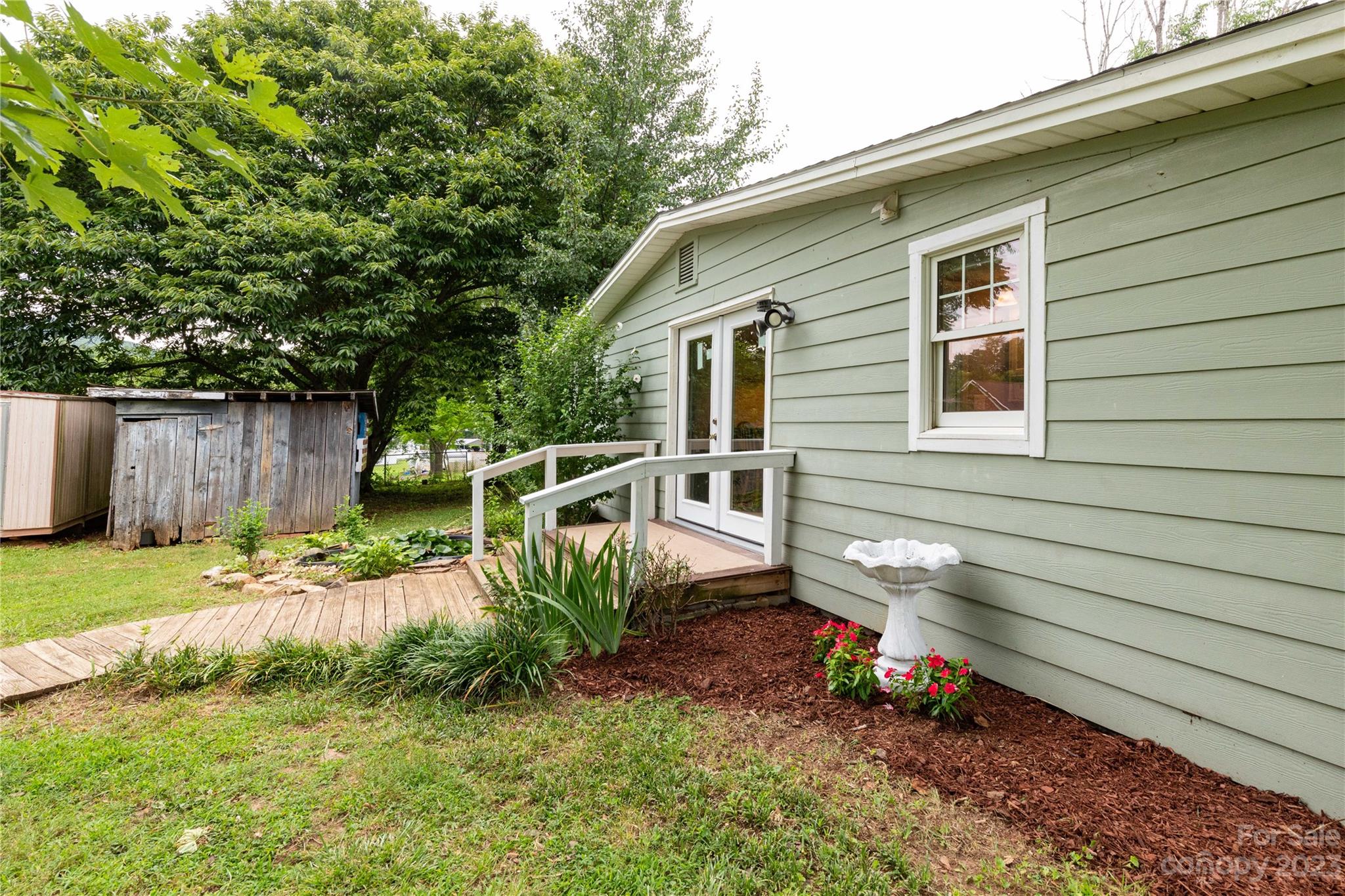 558 Jacktown Road Marion, NC 28752 - Photo 24 of 26 a view of a backyard with plants and a bench