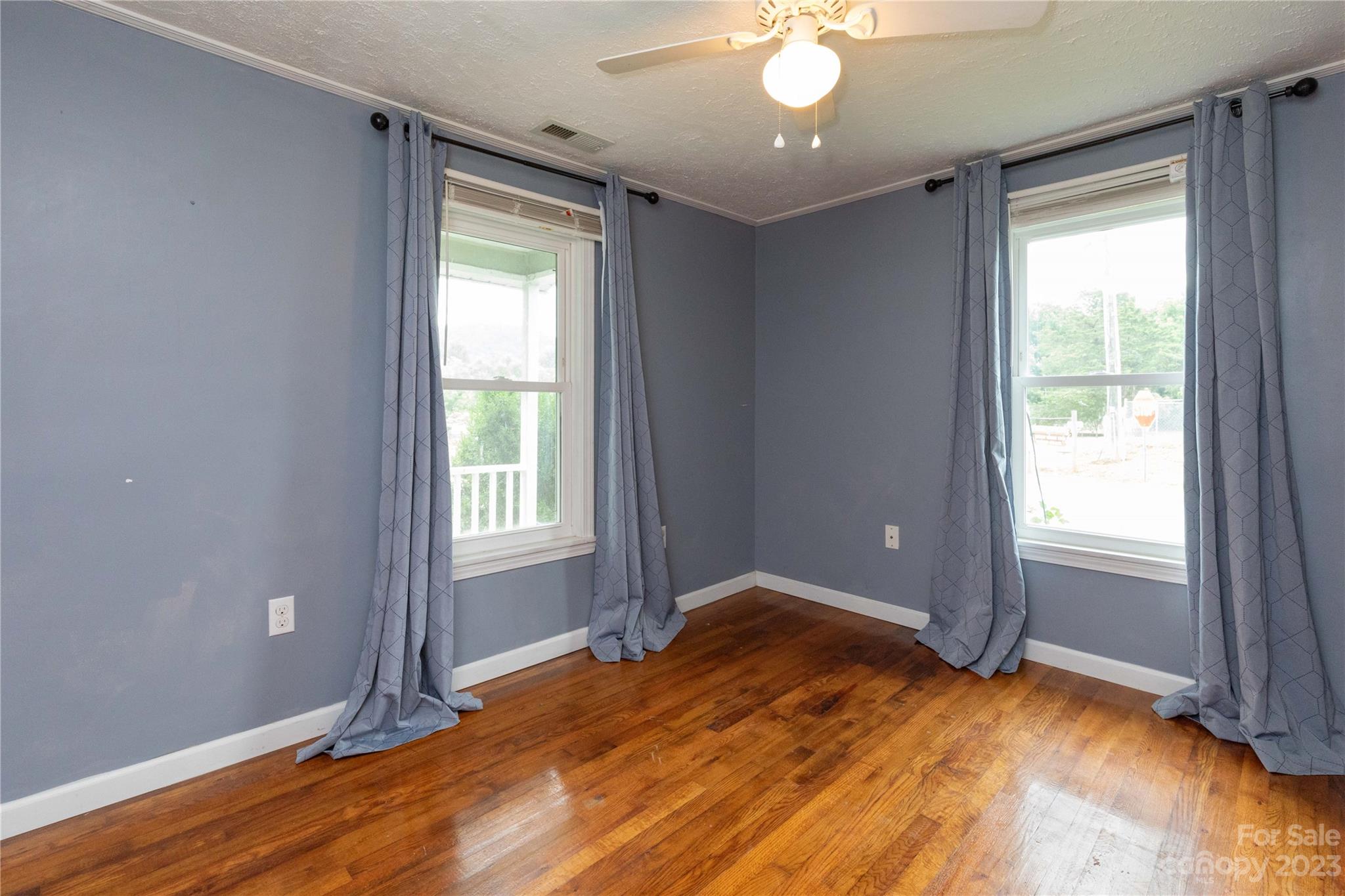 558 Jacktown Road Marion, NC 28752 - Photo 3 of 26 a view of an empty room with window and wooden floor