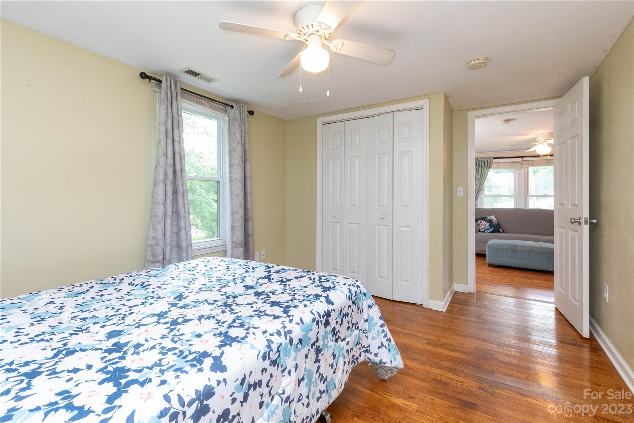 558 Jacktown Road Marion, NC 28752 - Photo 7 of 26 a bedroom with a bed and a chandelier