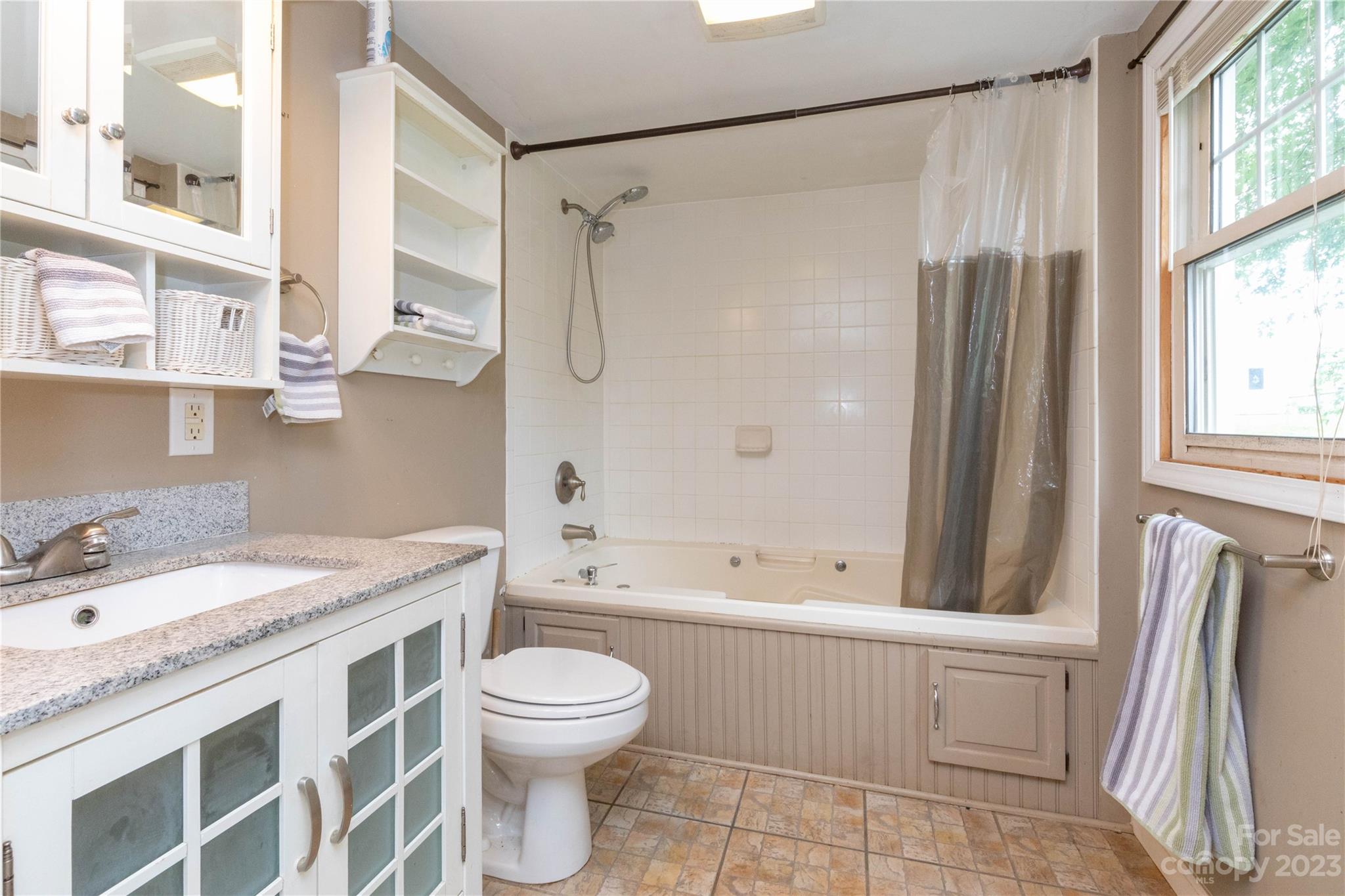 558 Jacktown Road Marion, NC 28752 - Photo 8 of 26 a bathroom with a granite countertop sink toilet and shower