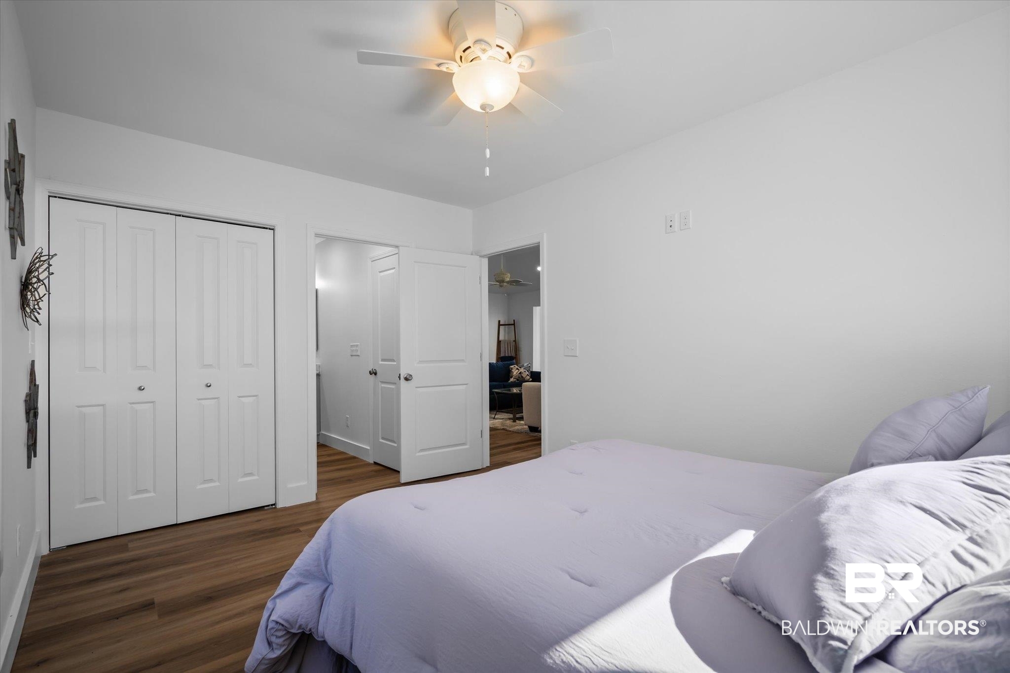 15111 Regus Road Coden, AL 36523 - Photo 11 of 35 Bedroom featuring a closet, a ceiling fan, and dark wood-type flooring