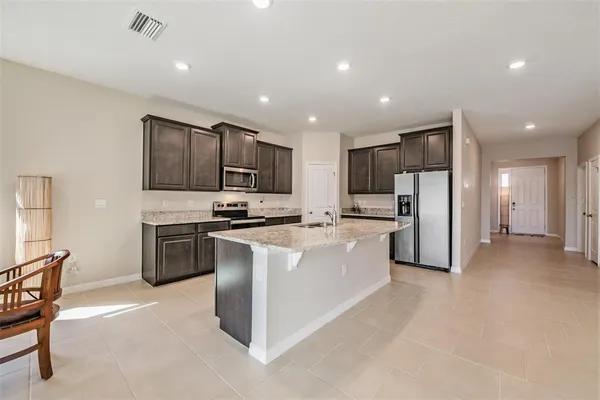 a kitchen with stainless steel appliances granite countertop a stove top oven a sink and dishwasher