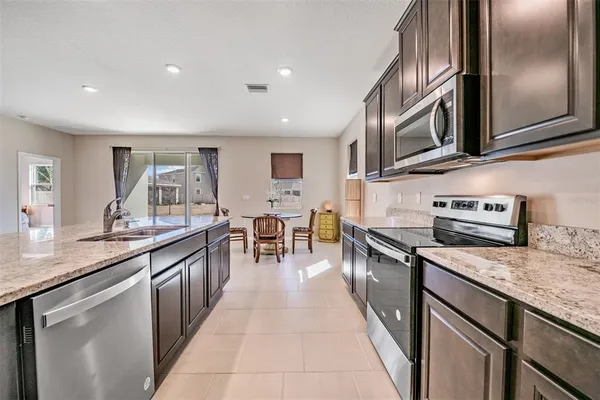 a kitchen with stainless steel appliances granite countertop a lot of counter space
