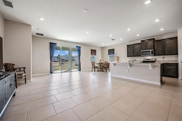 a large kitchen with stainless steel appliances granite countertop a stove and cabinets