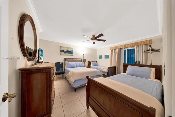 a bedroom with two beds and a mirror