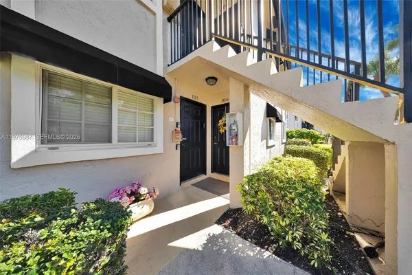 a front view of a house with a yard and flowers