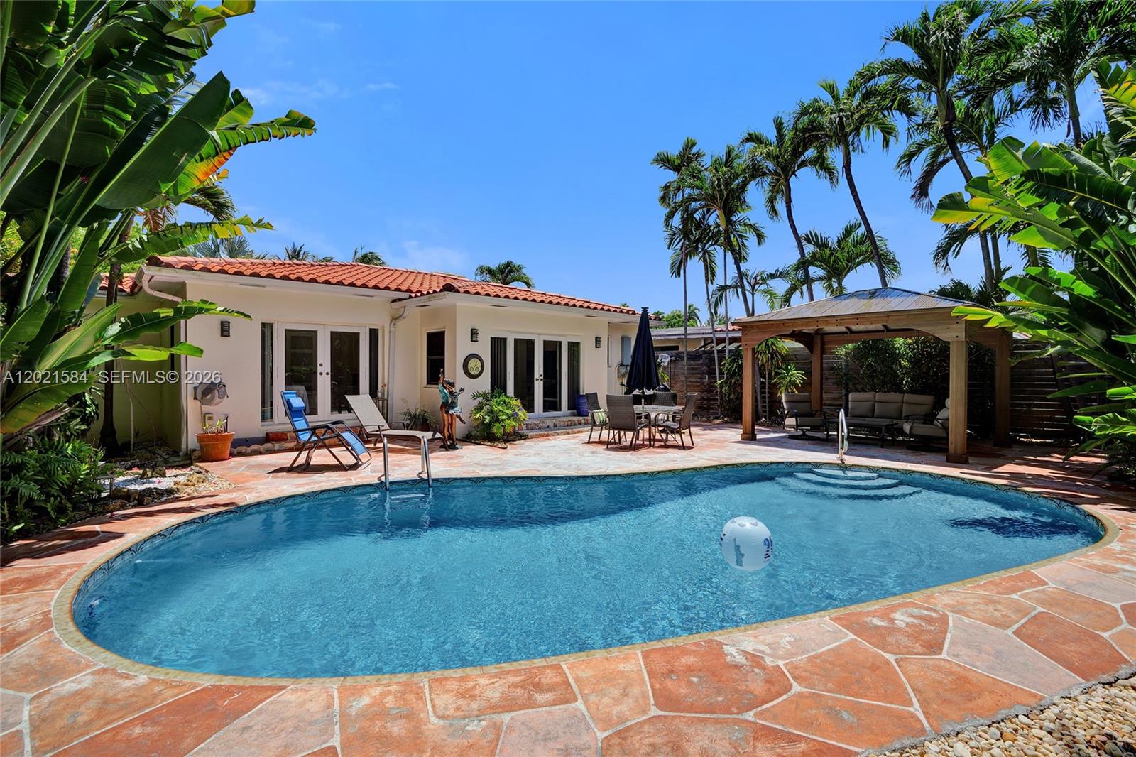 811 Northeast 73rd Street Miami, FL 33138 - Photo 19 of 51 a view of a house with swimming pool and sitting area