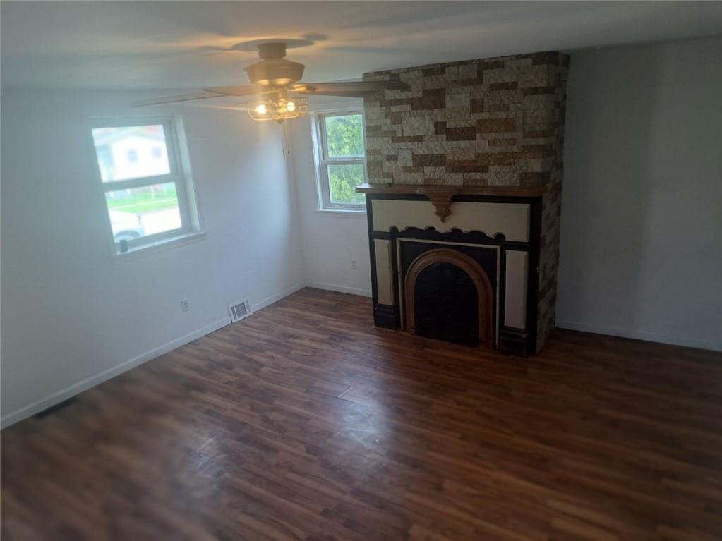 414 Liberty Street Perryopolis, PA 15473 - Photo 11 of 26 a view of empty room with wooden floor and fireplace