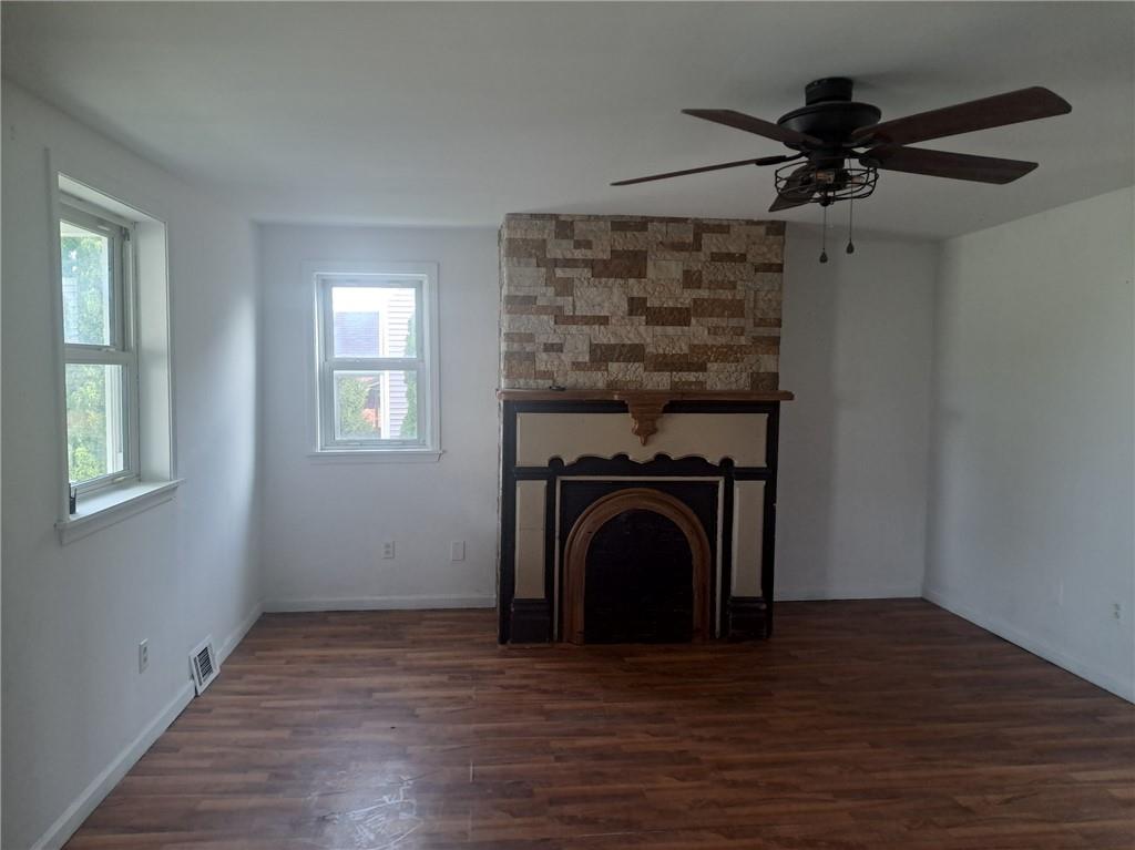 414 Liberty Street Perryopolis, PA 15473 - Photo 12 of 26 a view of a livingroom with a fireplace a ceiling fan and wooden floor