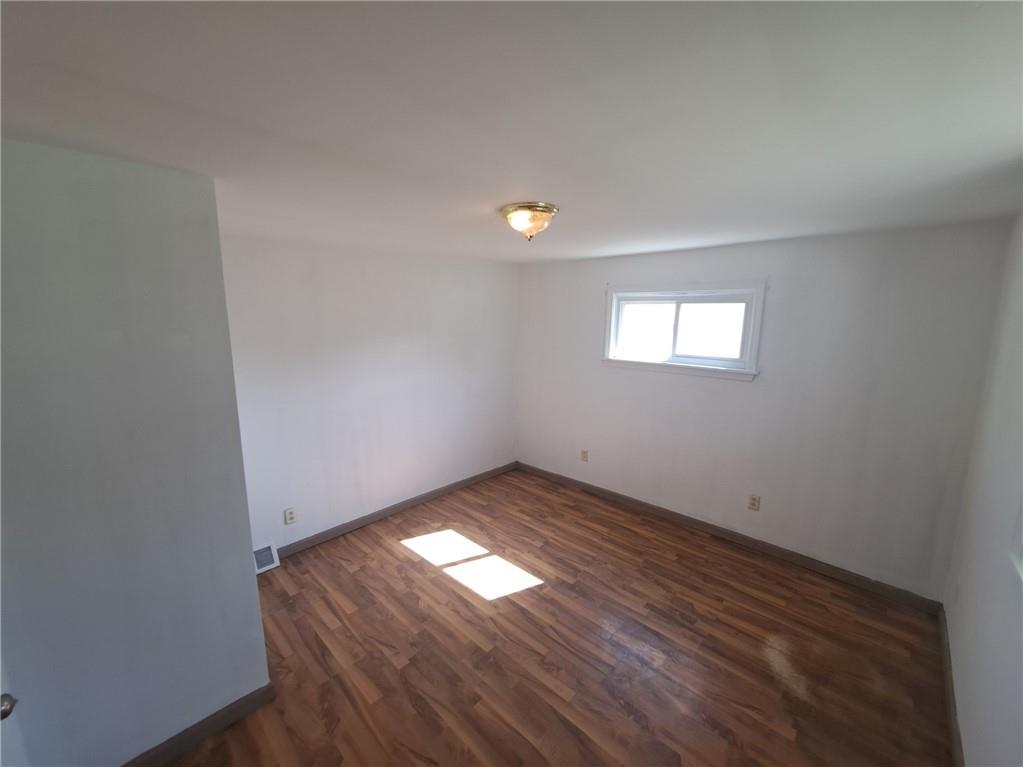 414 Liberty Street Perryopolis, PA 15473 - Photo 24 of 26 an empty room with wooden floor and windows