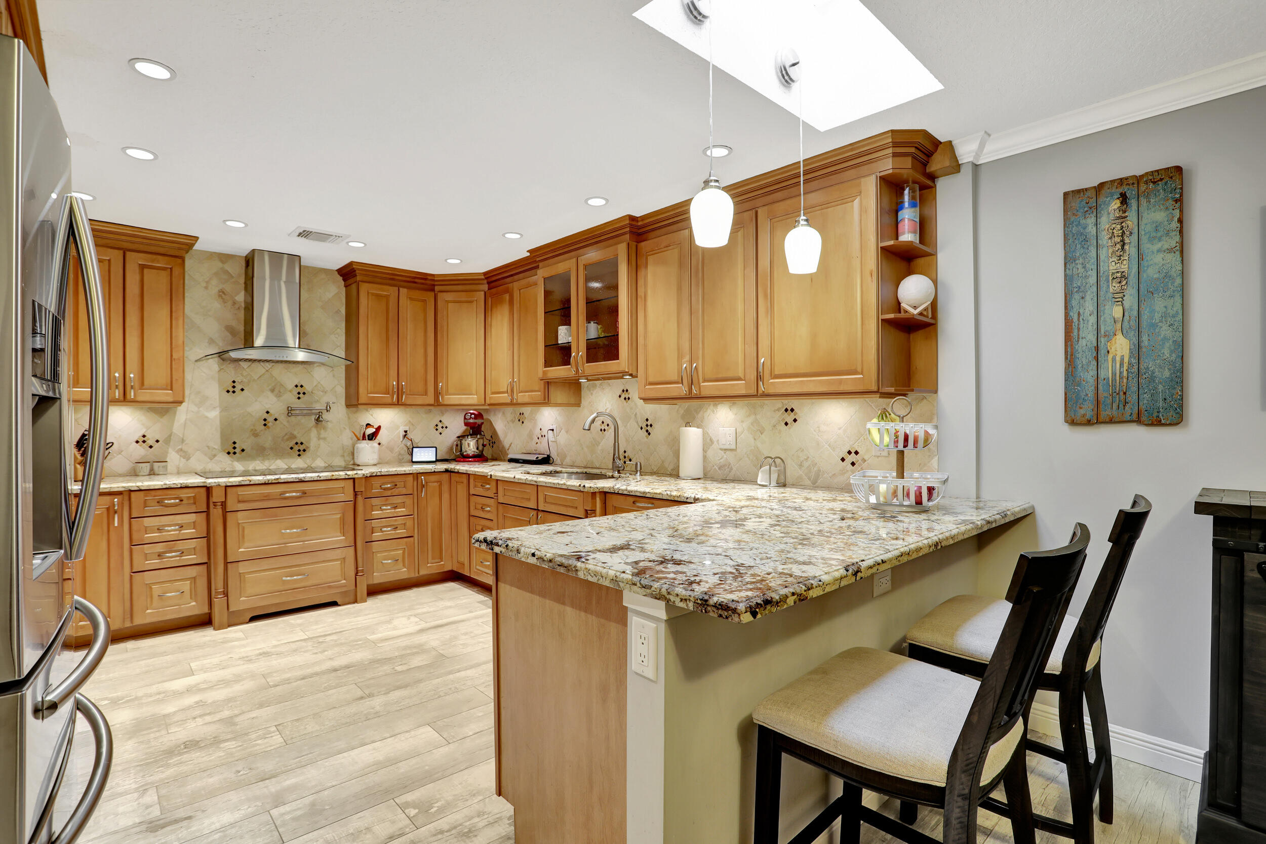 9142 Southwest 22nd Street, Unit E Boca Raton, FL 33428 - Photo 13 of 51 a kitchen with a table chairs sink and cabinets