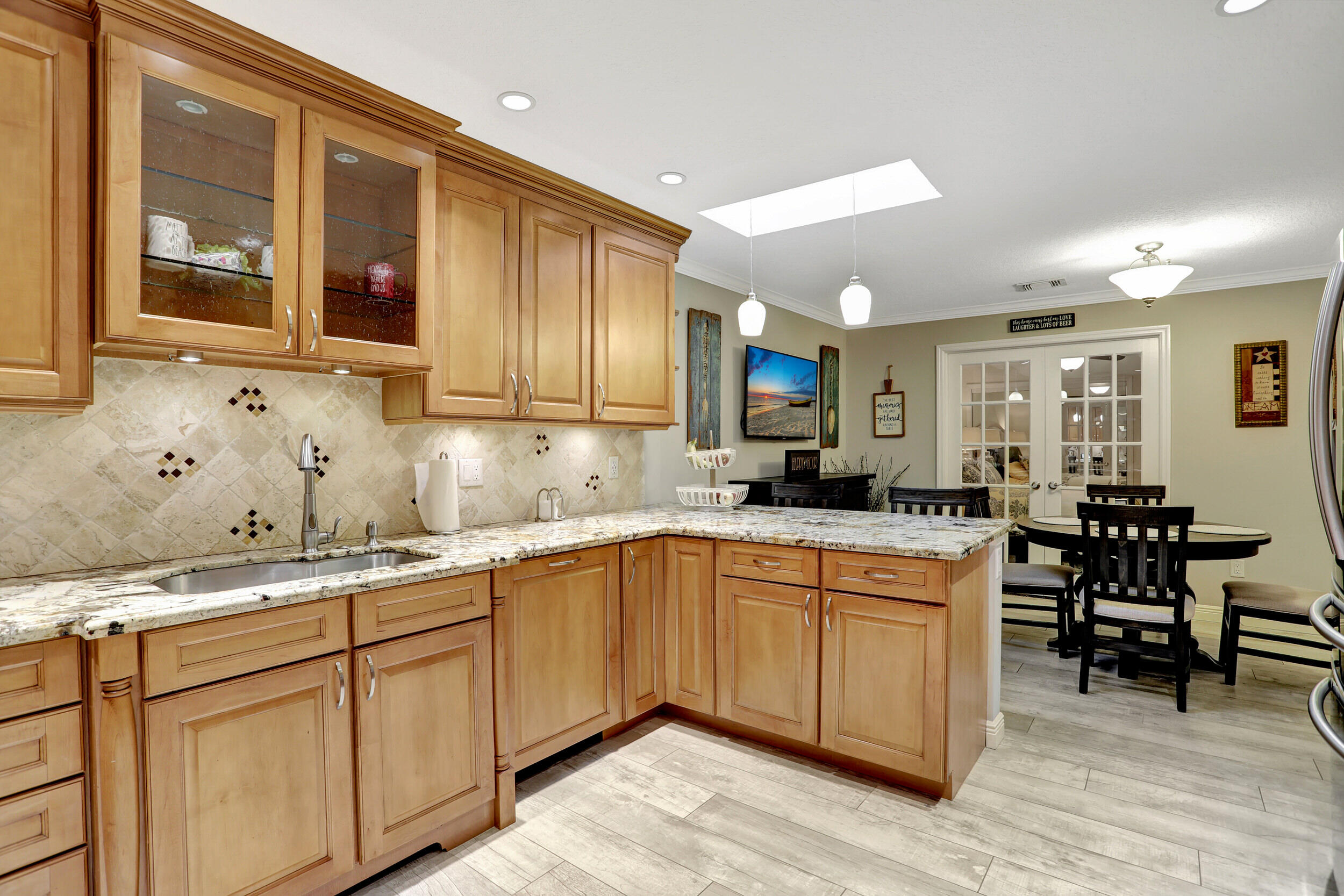9142 Southwest 22nd Street, Unit E Boca Raton, FL 33428 - Photo 14 of 51 a kitchen with a sink cabinets and wooden floor