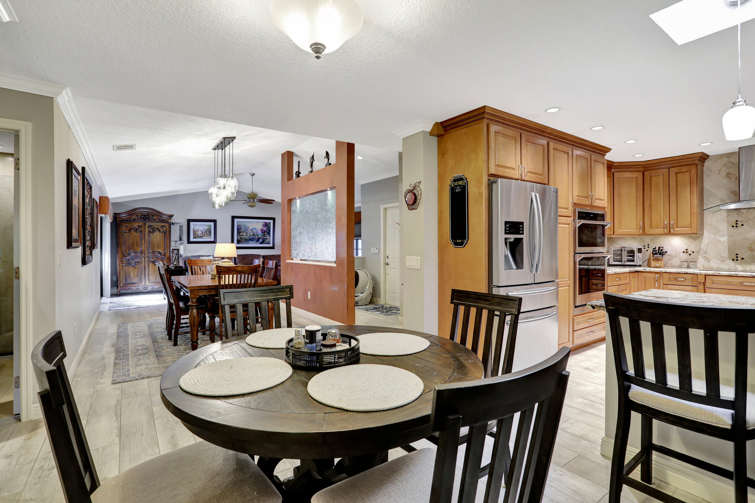 9142 Southwest 22nd Street, Unit E Boca Raton, FL 33428 - Photo 16 of 51 a view of a dining room with furniture and wooden floor