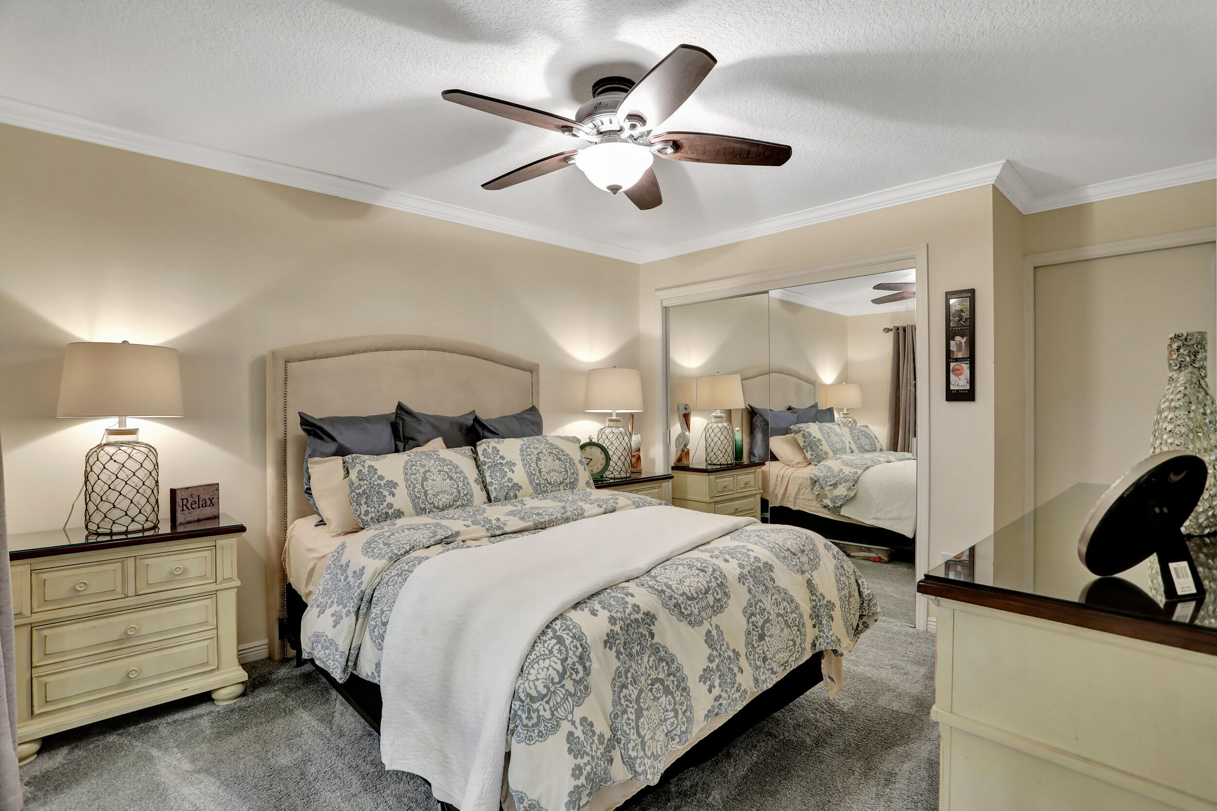 9142 Southwest 22nd Street, Unit E Boca Raton, FL 33428 - Photo 17 of 51 a bedroom with bed and a chandelier