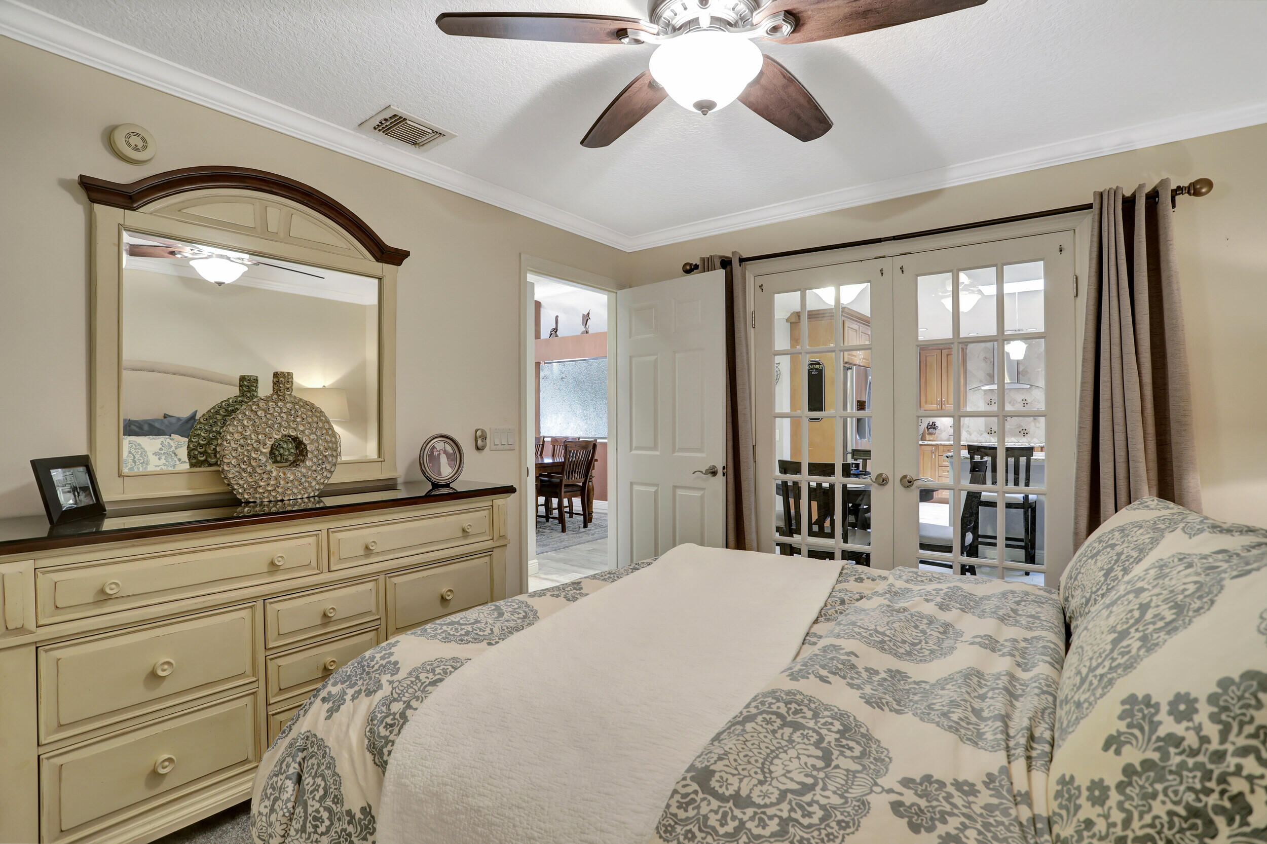 9142 Southwest 22nd Street, Unit E Boca Raton, FL 33428 - Photo 18 of 51 a bedroom with a large bed and a large mirror