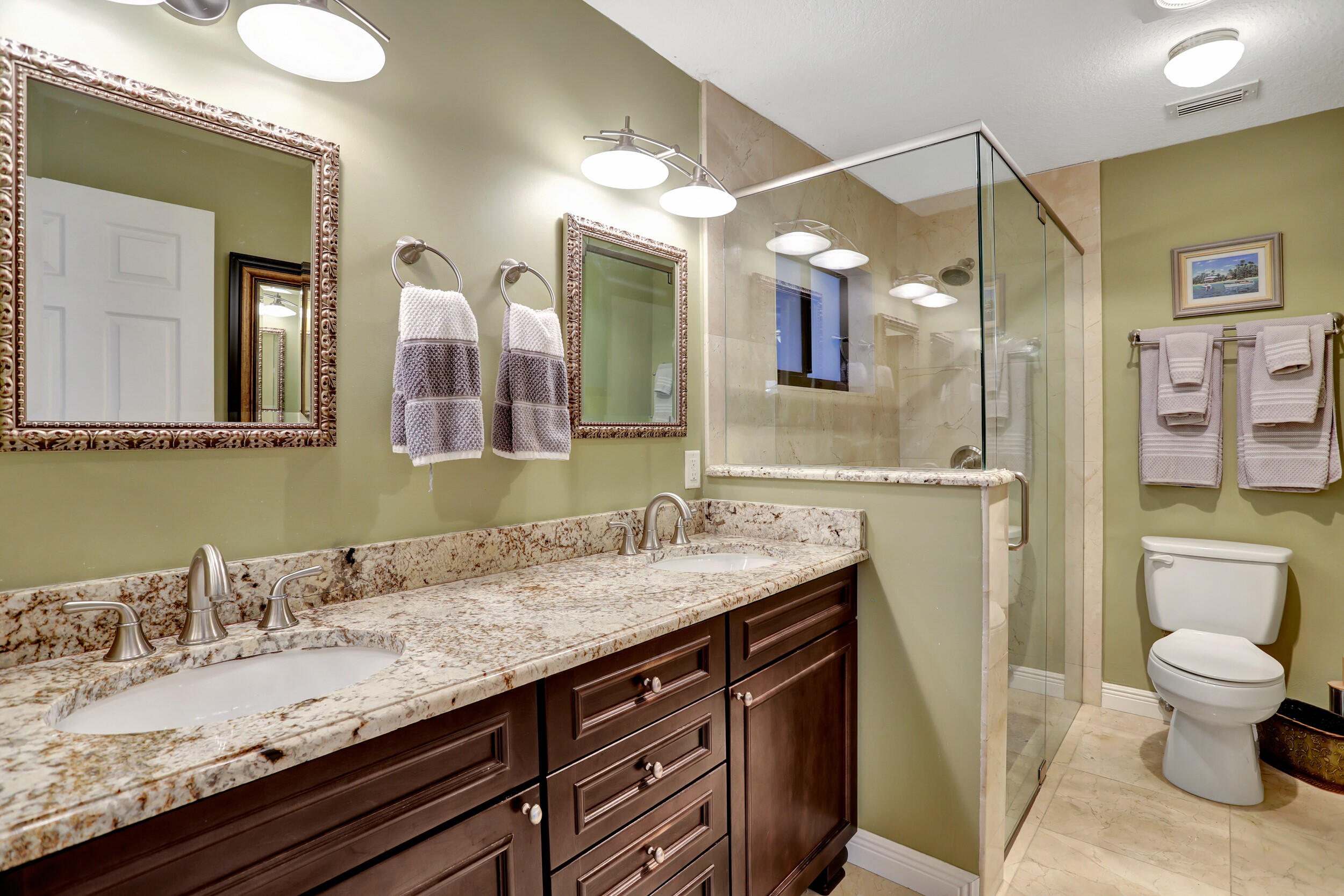 9142 Southwest 22nd Street, Unit E Boca Raton, FL 33428 - Photo 21 of 51 a bathroom with a granite countertop sink a toilet and a mirror