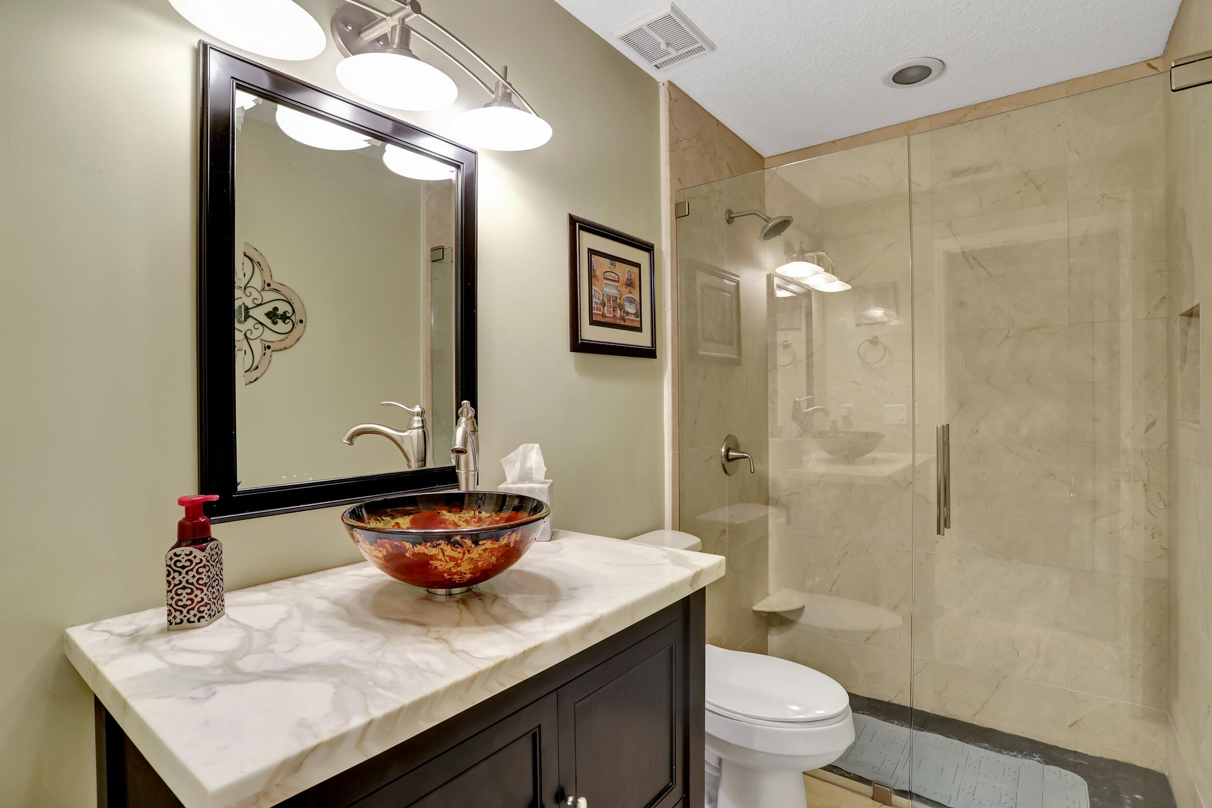 9142 Southwest 22nd Street, Unit E Boca Raton, FL 33428 - Photo 24 of 51 a bathroom with a sink a toilet and shower