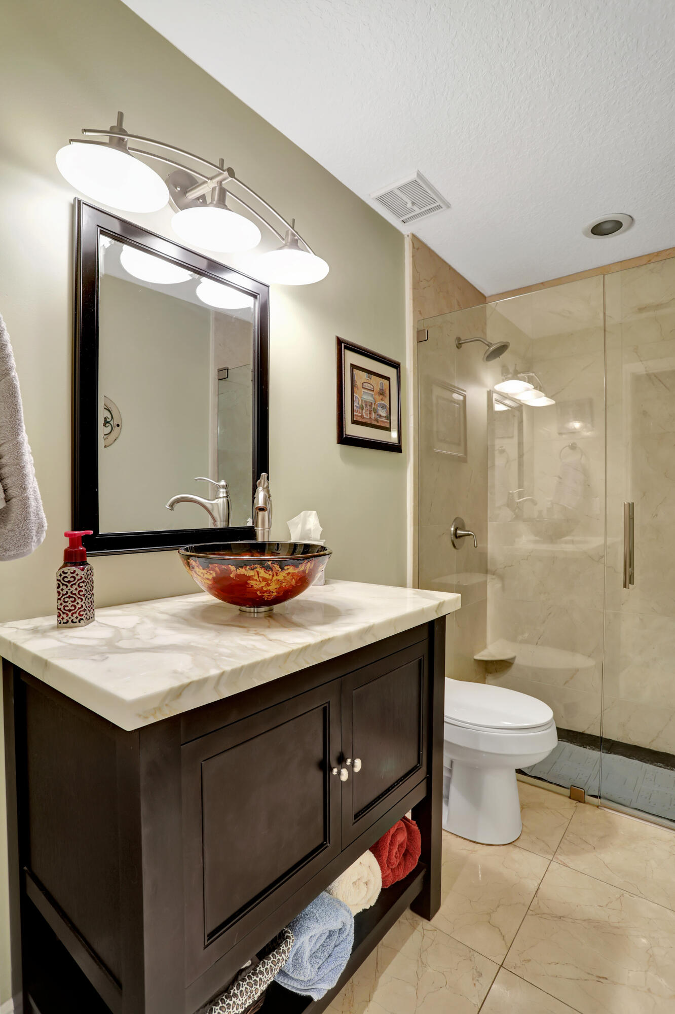 9142 Southwest 22nd Street, Unit E Boca Raton, FL 33428 - Photo 25 of 51 a bathroom with a toilet sink and mirror