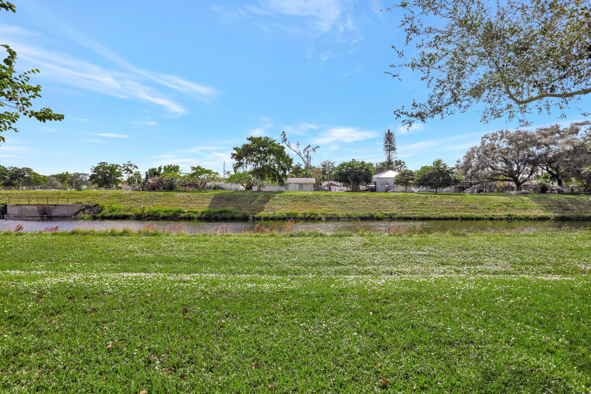 9142 Southwest 22nd Street, Unit E Boca Raton, FL 33428 - Photo 29 of 51 a view of a grassy field with an trees