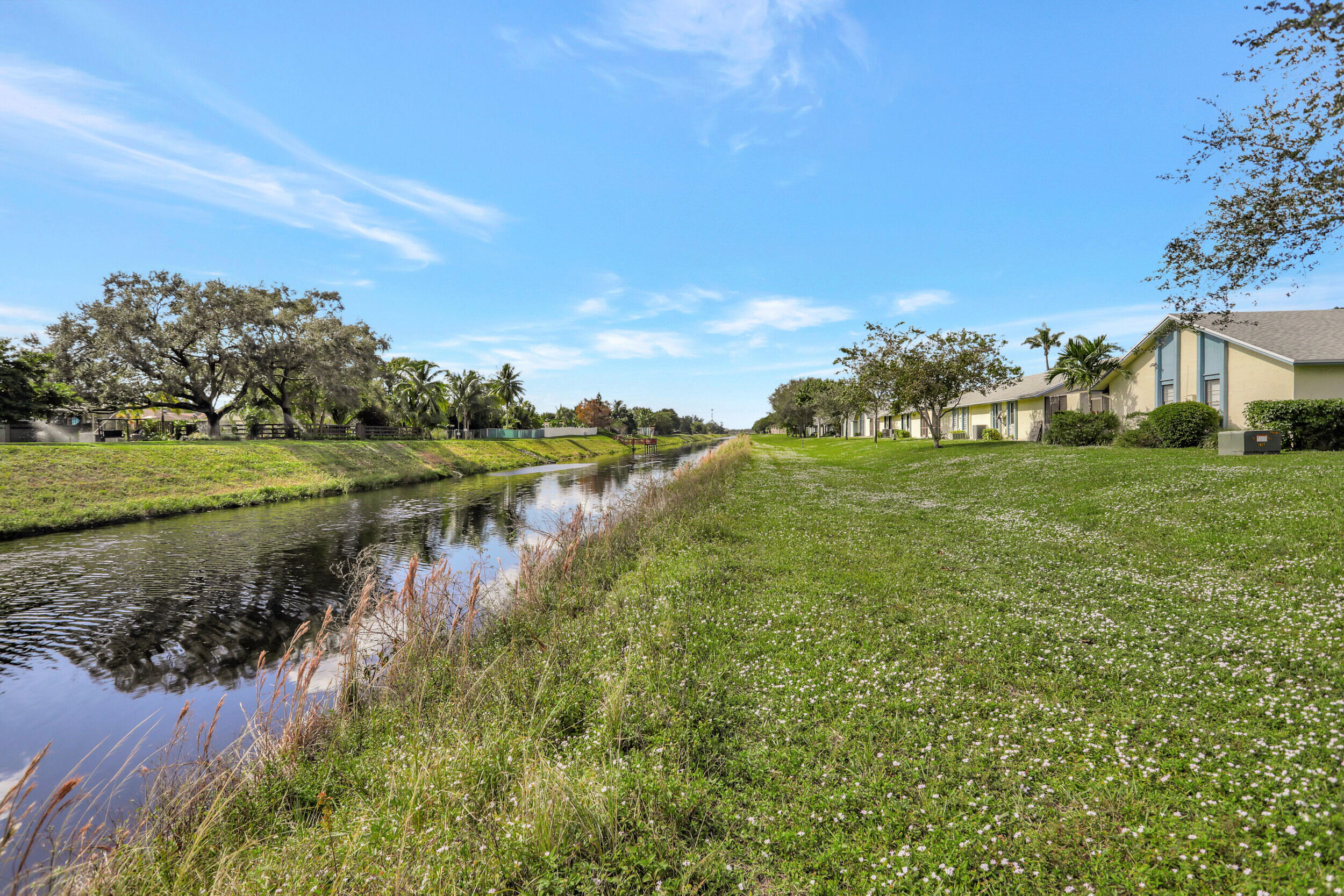 9142 Southwest 22nd Street, Unit E Boca Raton, FL 33428 - Photo 31 of 51 a view of a lake with a yard
