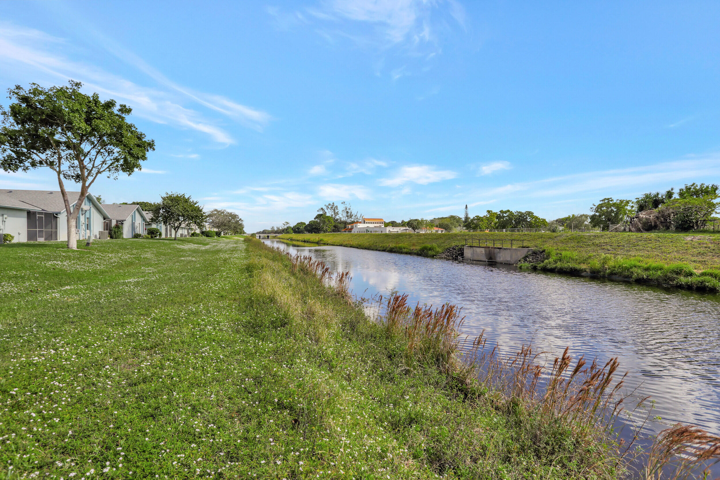 9142 Southwest 22nd Street, Unit E Boca Raton, FL 33428 - Photo 32 of 51 a view of a lake with houses in the back