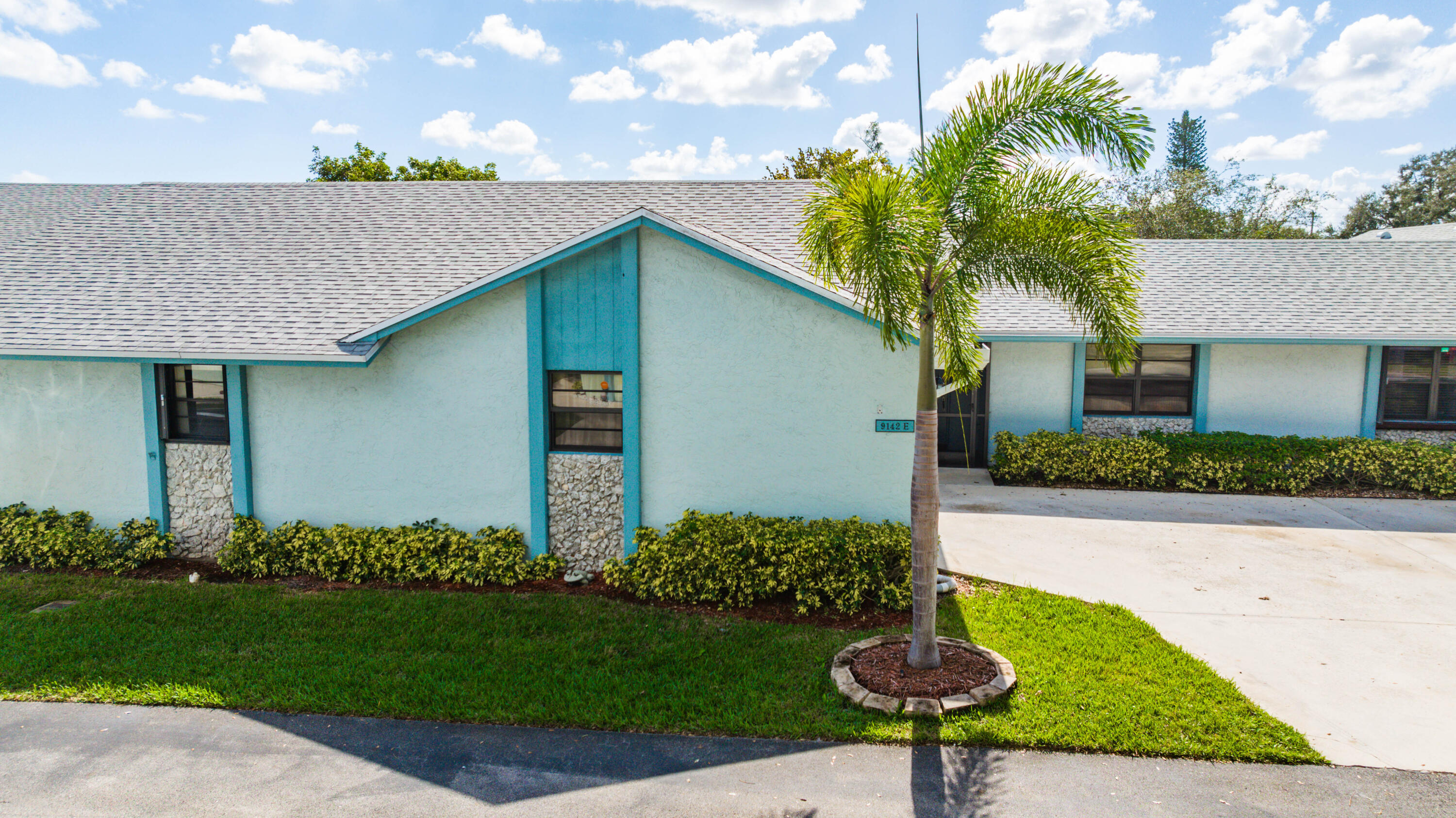9142 Southwest 22nd Street, Unit E Boca Raton, FL 33428 - Photo 49 of 51 a front view of a house with garden