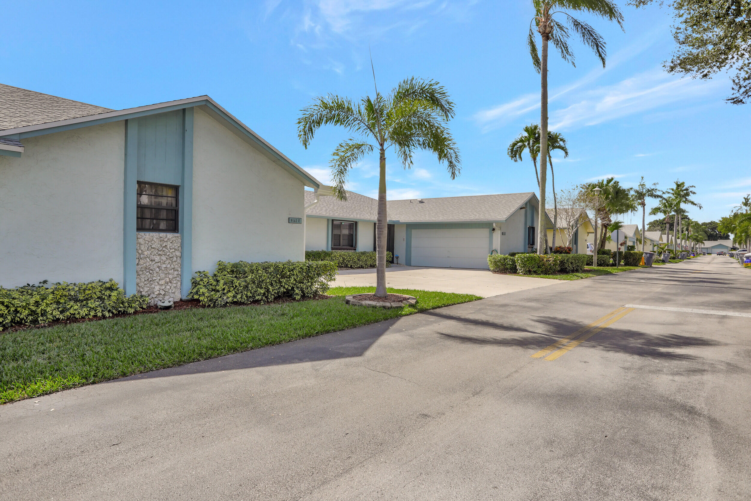 9142 Southwest 22nd Street, Unit E Boca Raton, FL 33428 - Photo 50 of 51 a front view of house with yard and trees around