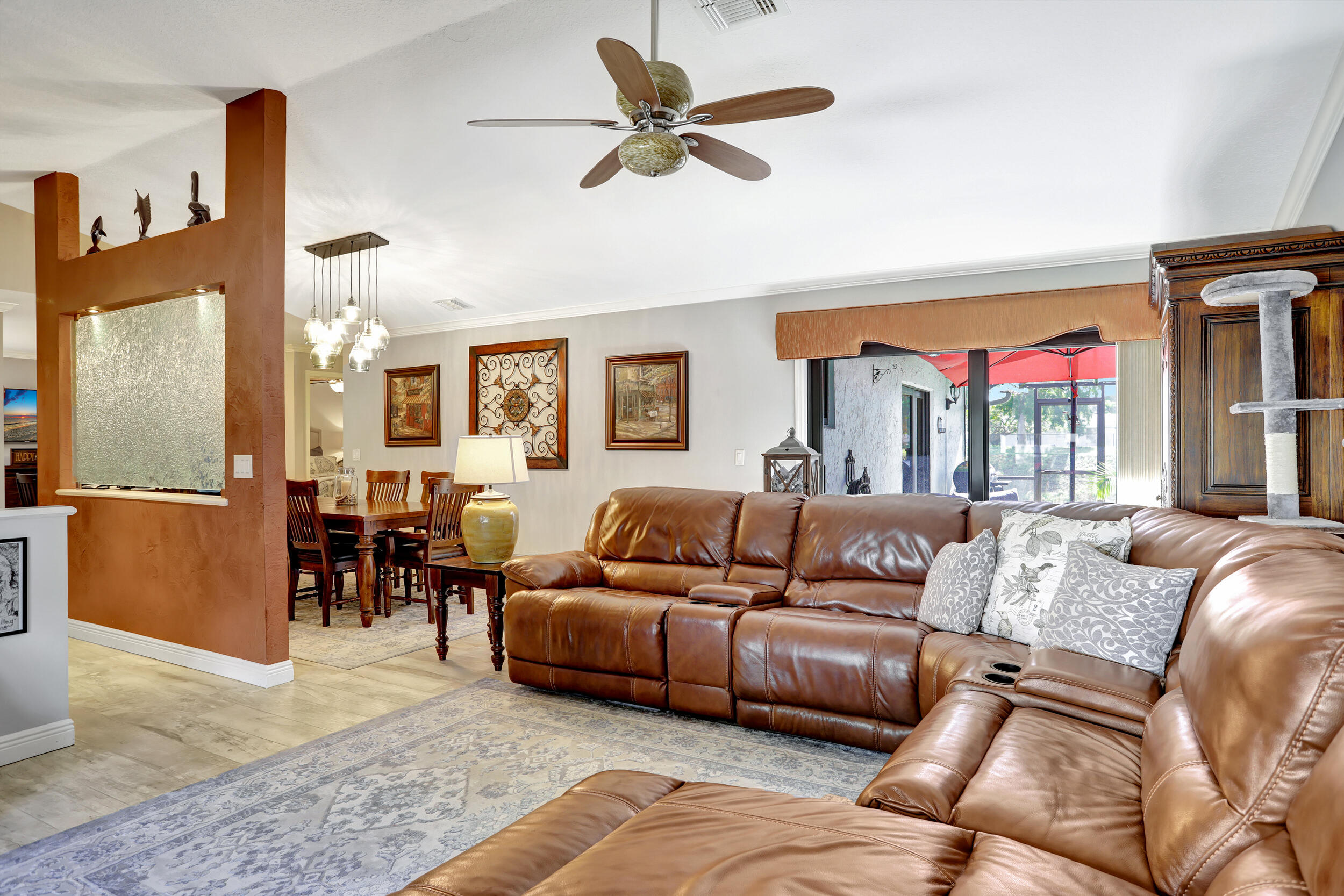 9142 Southwest 22nd Street, Unit E Boca Raton, FL 33428 - Photo 6 of 51 a living room with furniture ceiling fan and a rug