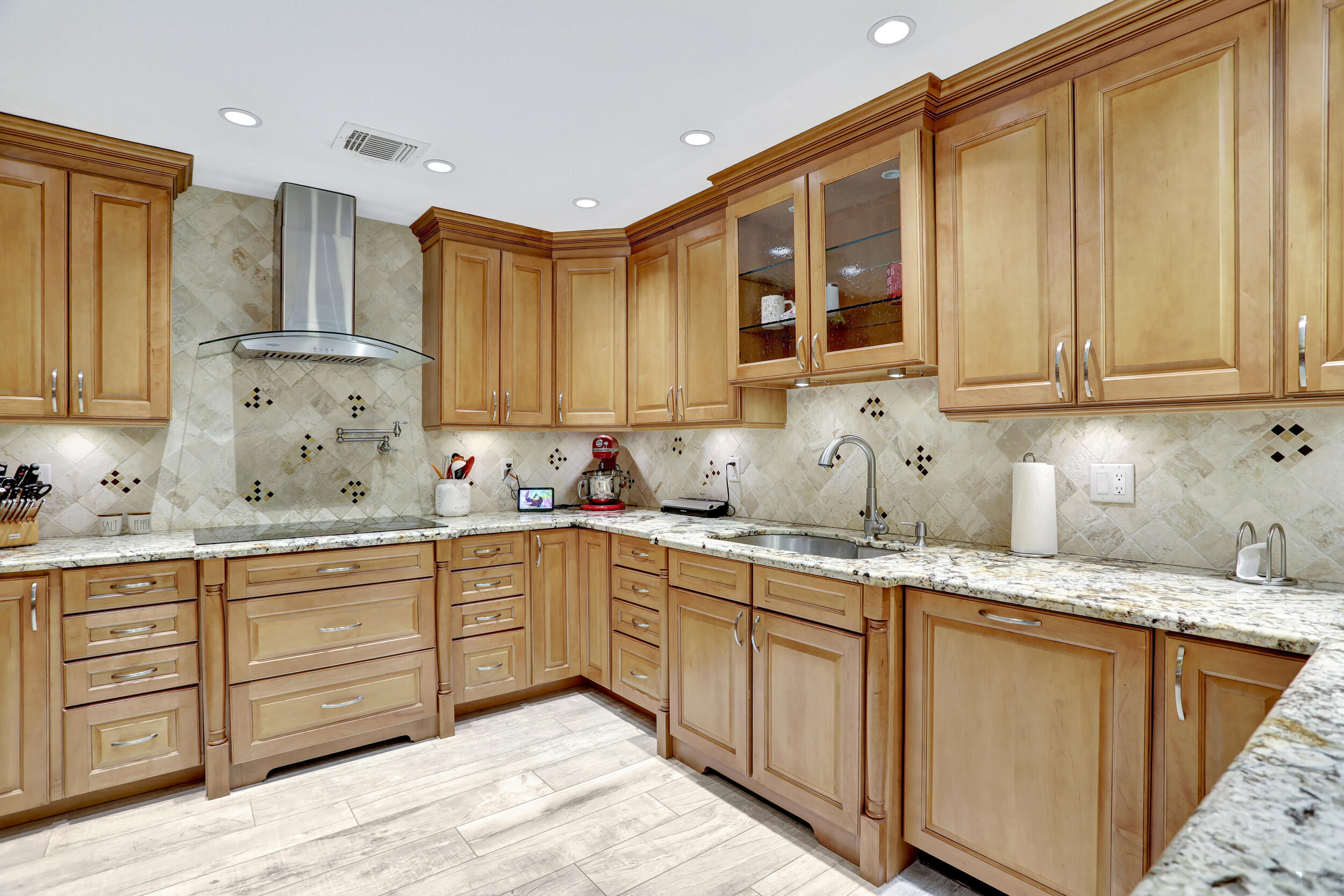 9142 Southwest 22nd Street, Unit E Boca Raton, FL 33428 - Photo 10 of 51 a kitchen with granite countertop wooden cabinets and sink