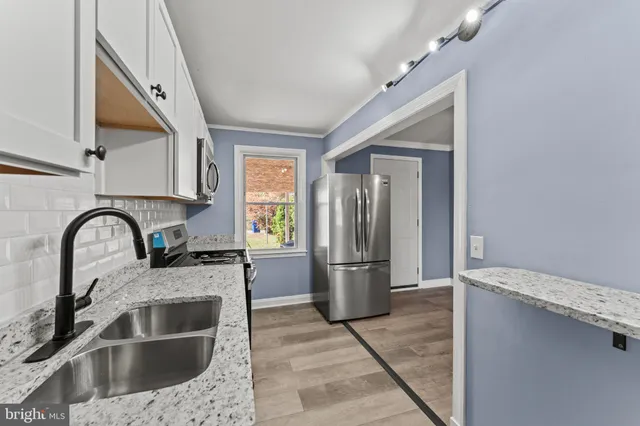 a kitchen with a refrigerator and a sink