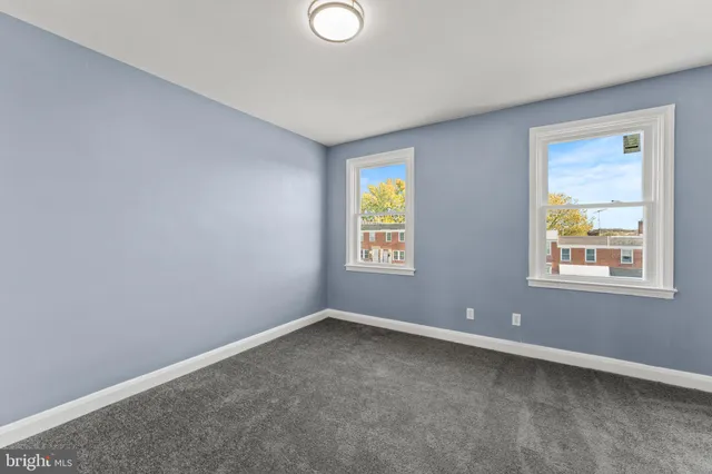 an empty room with windows and closet