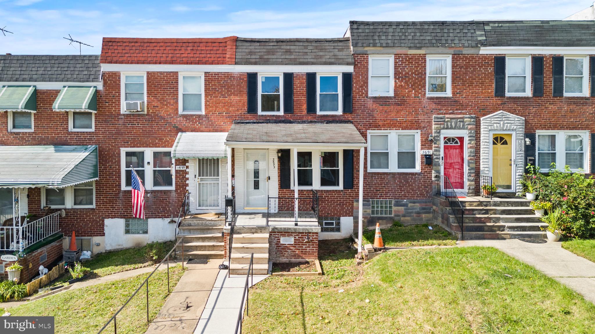 3693 Kenyon Avenue Baltimore, MD 21213 - Photo 2 of 34 front view of a brick house with a yard
