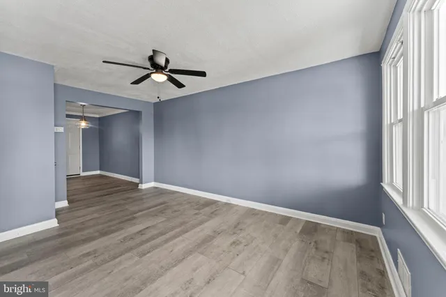 wooden floor in an empty room with a window