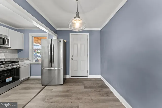 a kitchen with stainless steel appliances granite countertop a refrigerator a stove a microwave and a refrigerator