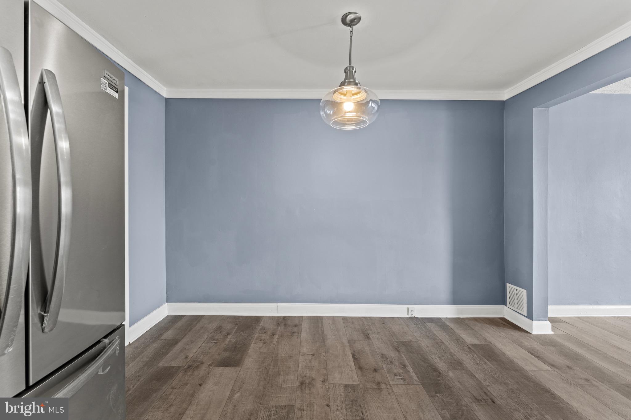 3693 Kenyon Avenue Baltimore, MD 21213 - Photo 9 of 34 a view of an empty room with wooden floor and a window